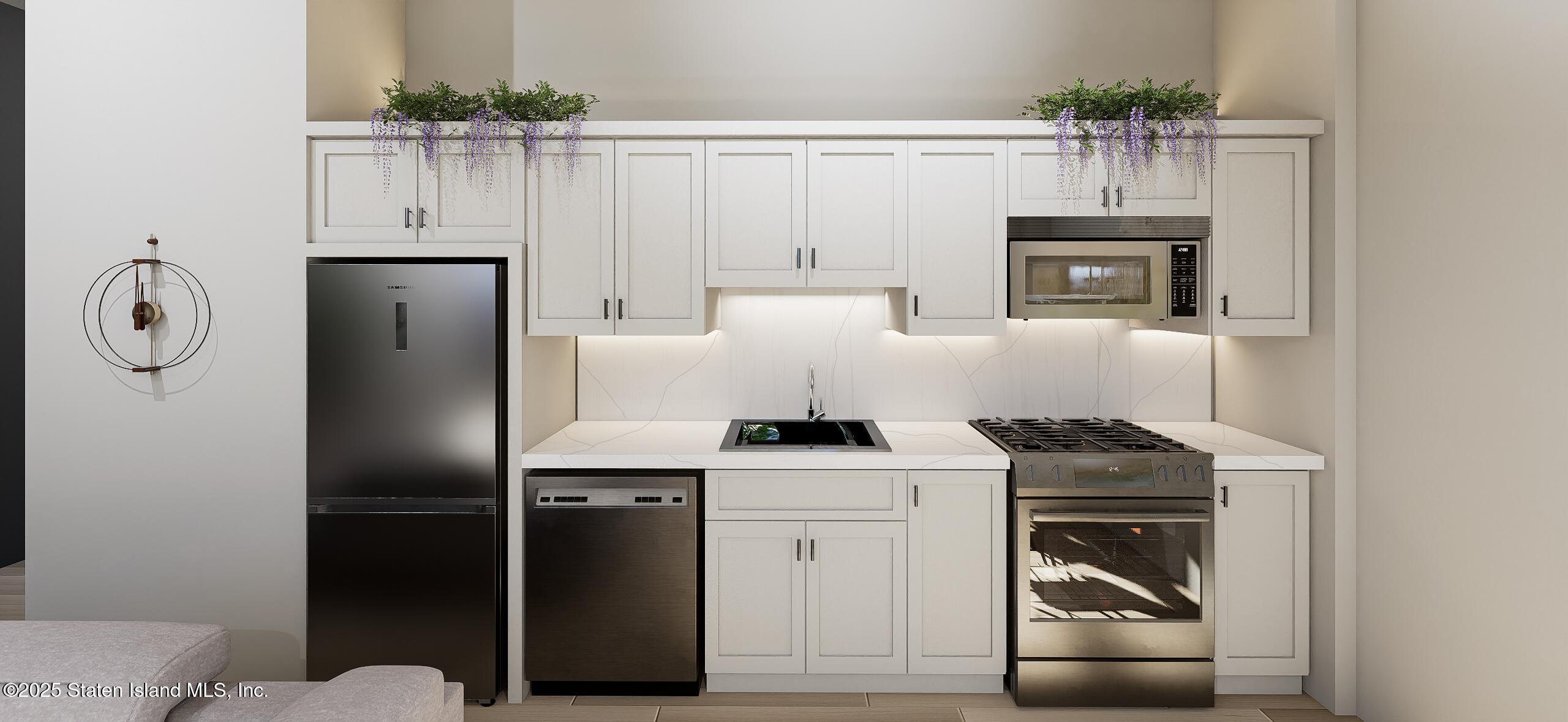 1239 Forest Hill Road, Unit 7 Staten Island, NY 10314 - Photo 9 of 15 a kitchen with a refrigerator sink and cabinets