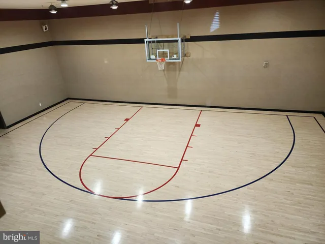 a room with pool table and windows