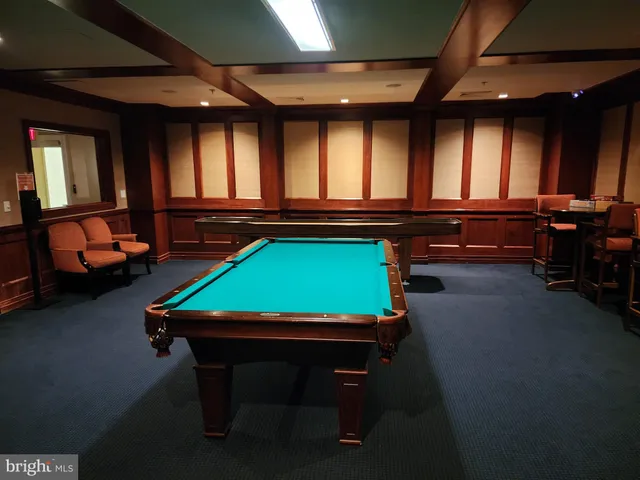 a view of a swimming pool with an outdoor space and seating area