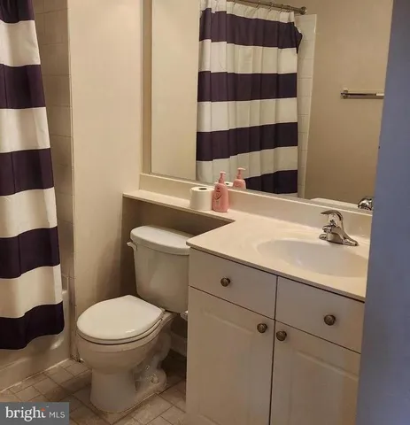 a bathroom with a sink a toilet a mirror and shower