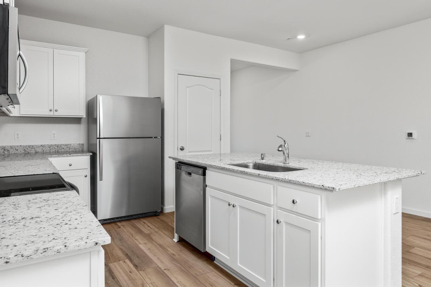6691 Snedigar Road Riverbank, CA 95367 - Photo 5 of 12 a kitchen with a sink a refrigerator and a stove