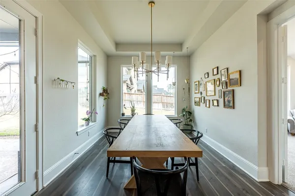 a large kitchen with stainless steel appliances granite countertop a lot of counter space and wooden floors