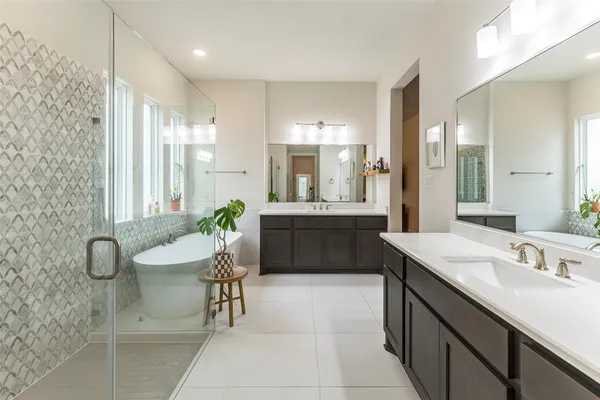 a bedroom with a bed mirror and window