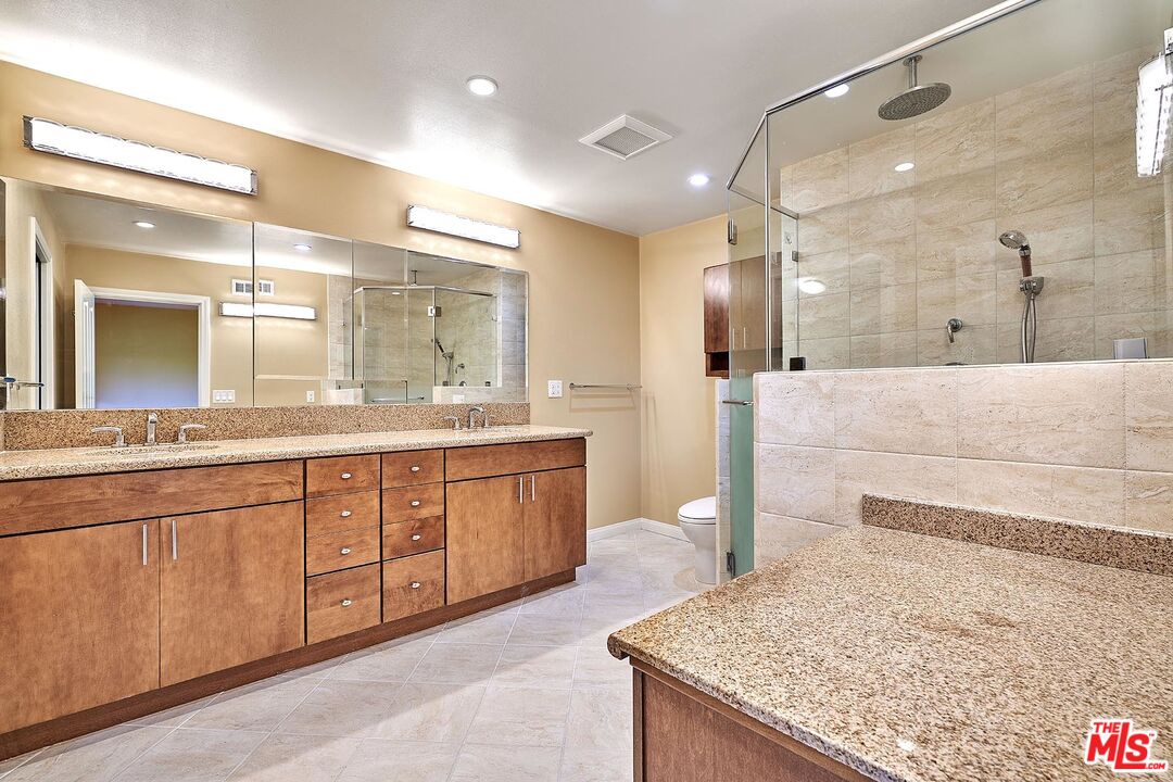 28227 Ridgepoint Court Rancho Palos Verdes, CA 90275 - Photo 11 of 34 a spacious bathroom with a granite countertop sink and a mirror