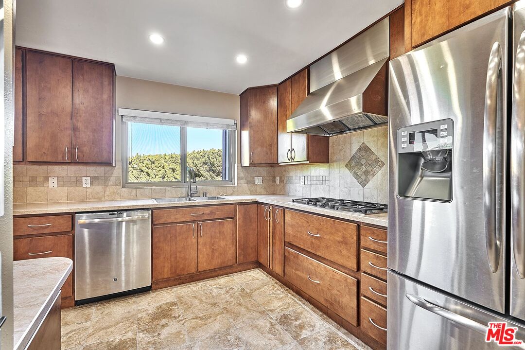 28227 Ridgepoint Court Rancho Palos Verdes, CA 90275 - Photo 18 of 34 a kitchen with stainless steel appliances granite countertop a refrigerator a sink dishwasher a stove and white countertops with wooden floor