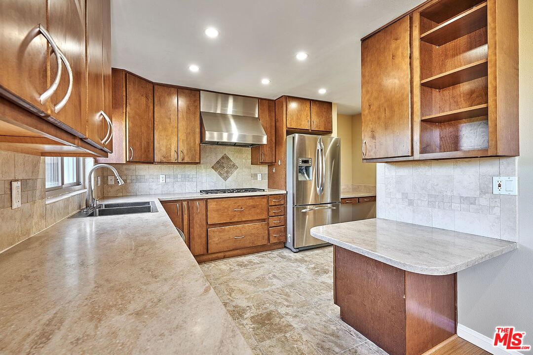28227 Ridgepoint Court Rancho Palos Verdes, CA 90275 - Photo 19 of 34 a large kitchen with stainless steel appliances kitchen island a large counter top and a refrigerator