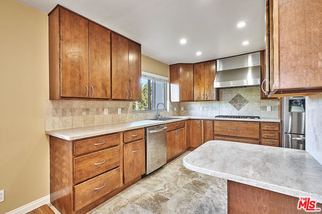 28227 Ridgepoint Court Rancho Palos Verdes, CA 90275 - Photo 20 of 34 a kitchen with stainless steel appliances granite countertop wooden cabinets a sink and dishwasher
