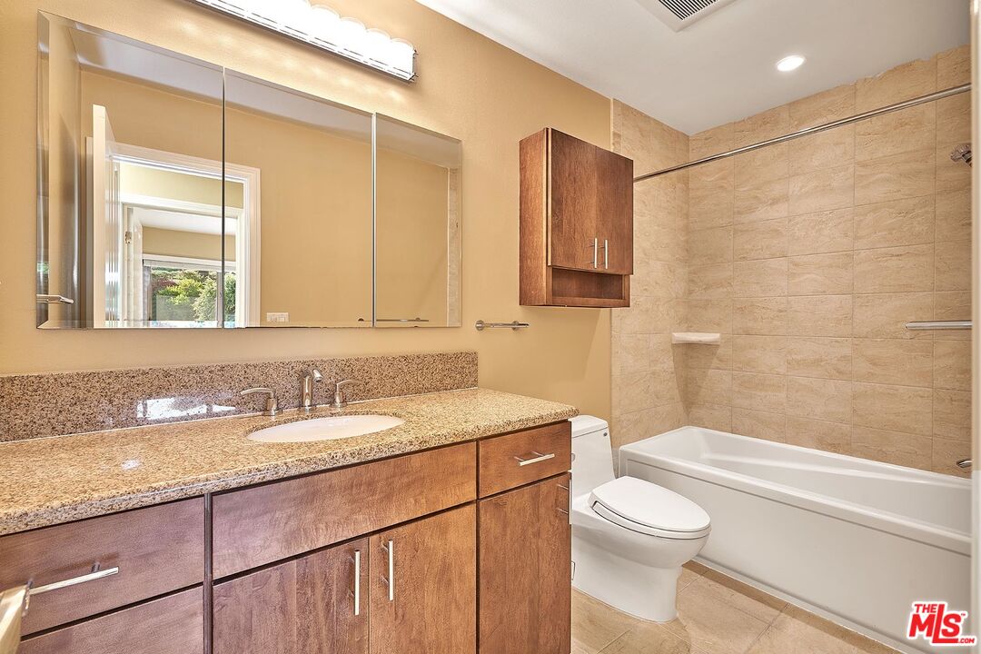 28227 Ridgepoint Court Rancho Palos Verdes, CA 90275 - Photo 3 of 34 a bathroom with a granite countertop sink a toilet a mirror and shower