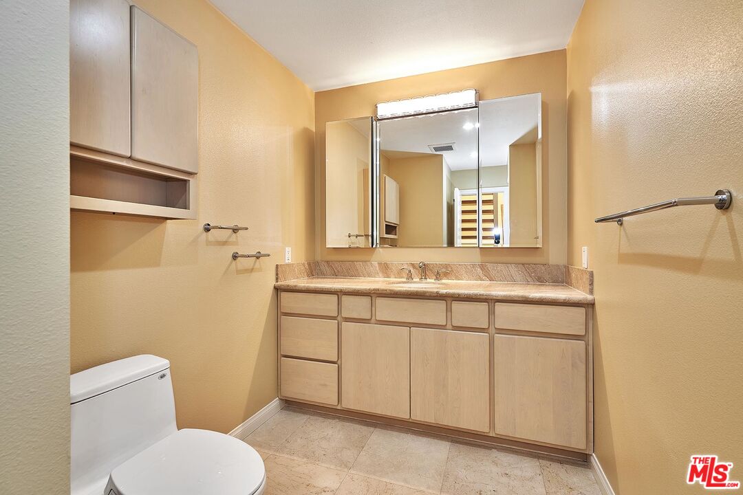 28227 Ridgepoint Court Rancho Palos Verdes, CA 90275 - Photo 26 of 34 a bathroom with a granite countertop toilet sink and mirror