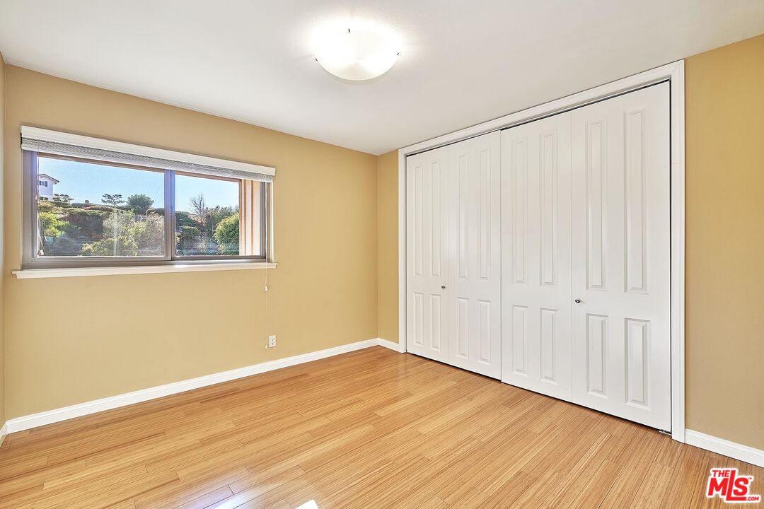 28227 Ridgepoint Court Rancho Palos Verdes, CA 90275 - Photo 8 of 34 a view of an empty room with wooden floor and a window