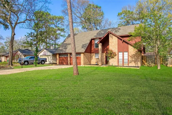 a view of a house with a backyard