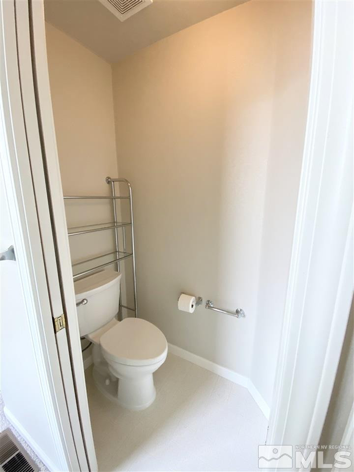 901 South University Park Loop Reno, NV 89512 - Photo 8 of 20 a white toilet sitting next to a white sink