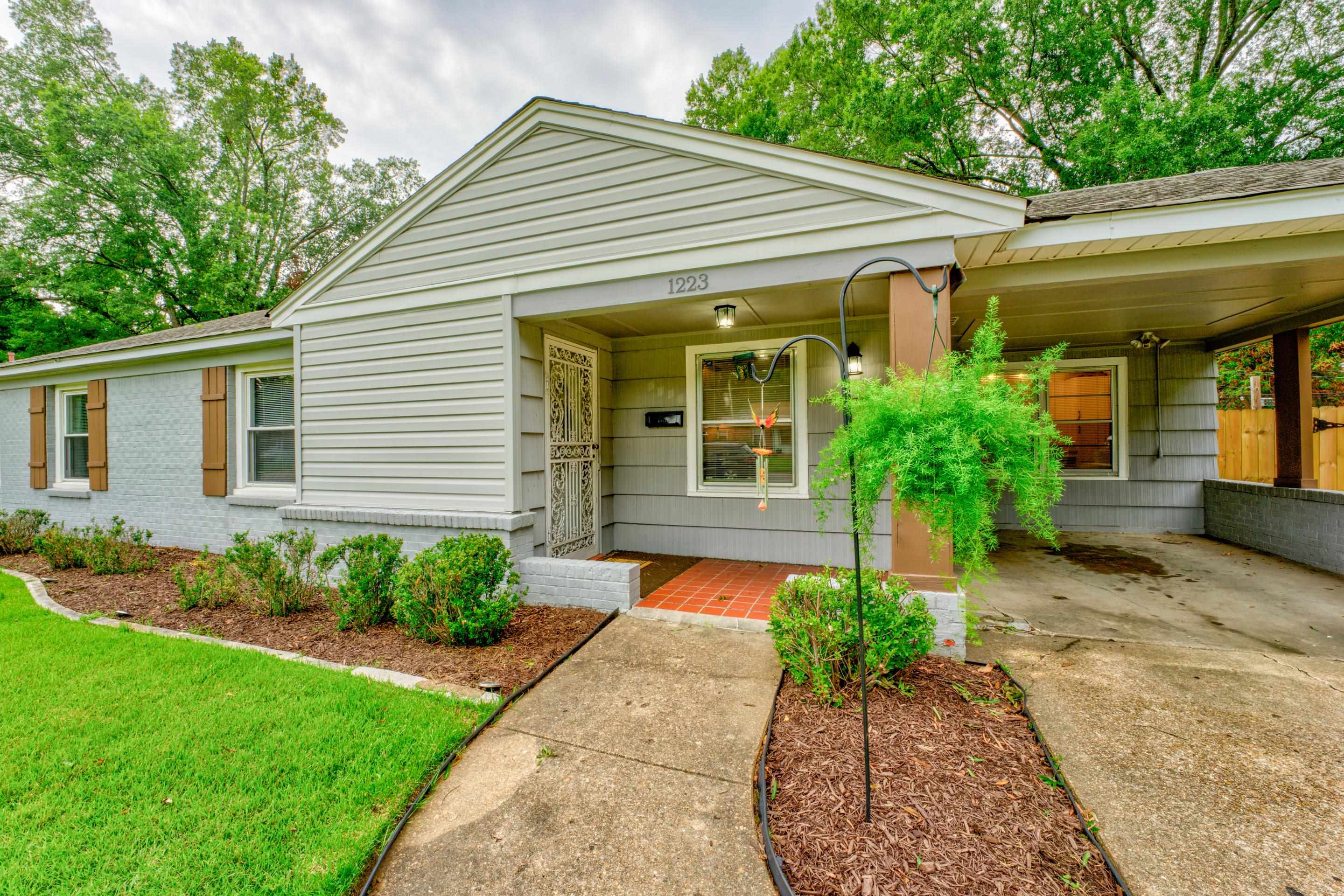 1223 Dearing Road Memphis, TN 38117 - Photo 2 of 34 a front view of a house with a yard and potted plants