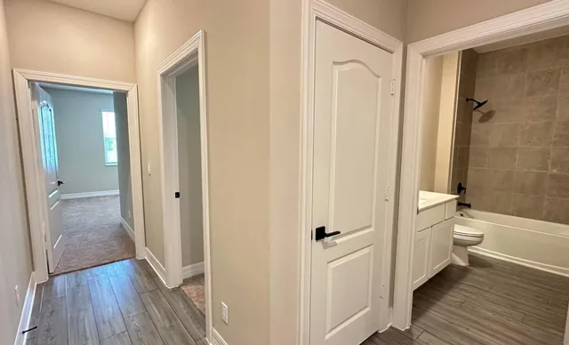 a bathroom with a granite countertop toilet a sink and shower