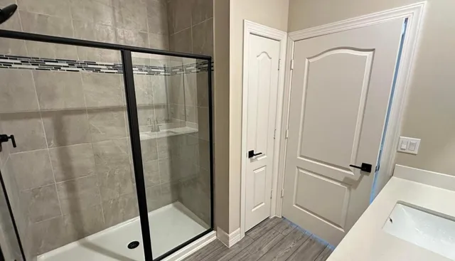 a bathroom with a glass shower door