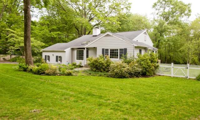 65 Partrick Road Westport, CT 06880 - Photo 1 of 1 a front view of a house with a yard