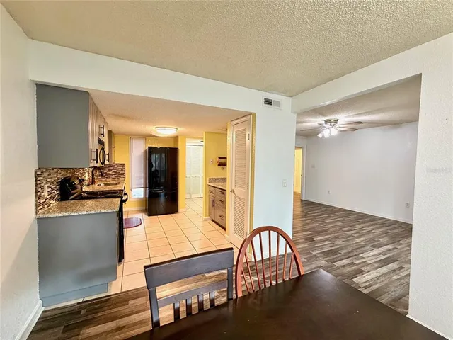 a kitchen with stainless steel appliances granite countertop a stove refrigerator and cabinets