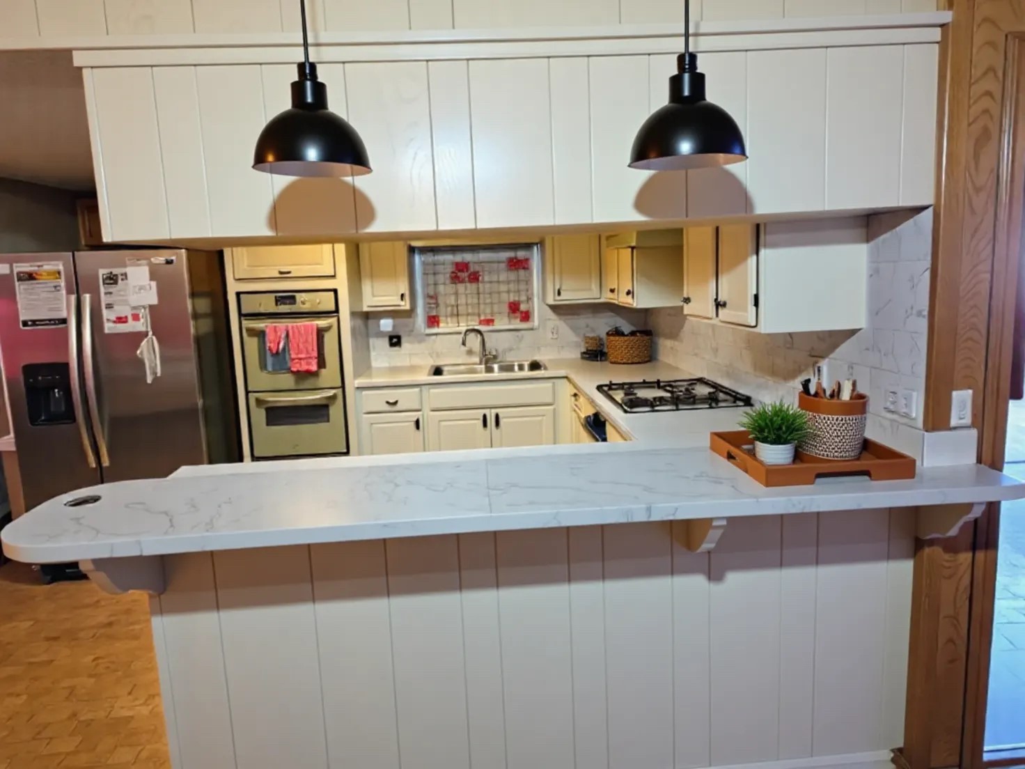 1305 2nd Street Hempstead, TX 77445 - Photo 12 of 24 a kitchen with stainless steel appliances granite countertop a sink a stove and a wooden floors