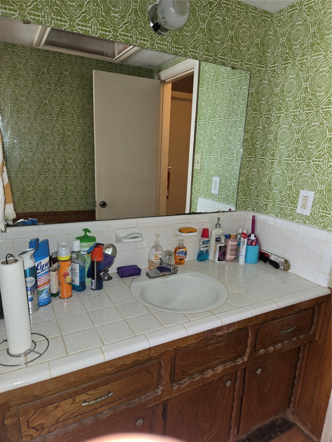 1305 2nd Street Hempstead, TX 77445 - Photo 22 of 24 a bathroom with a sink and a mirror