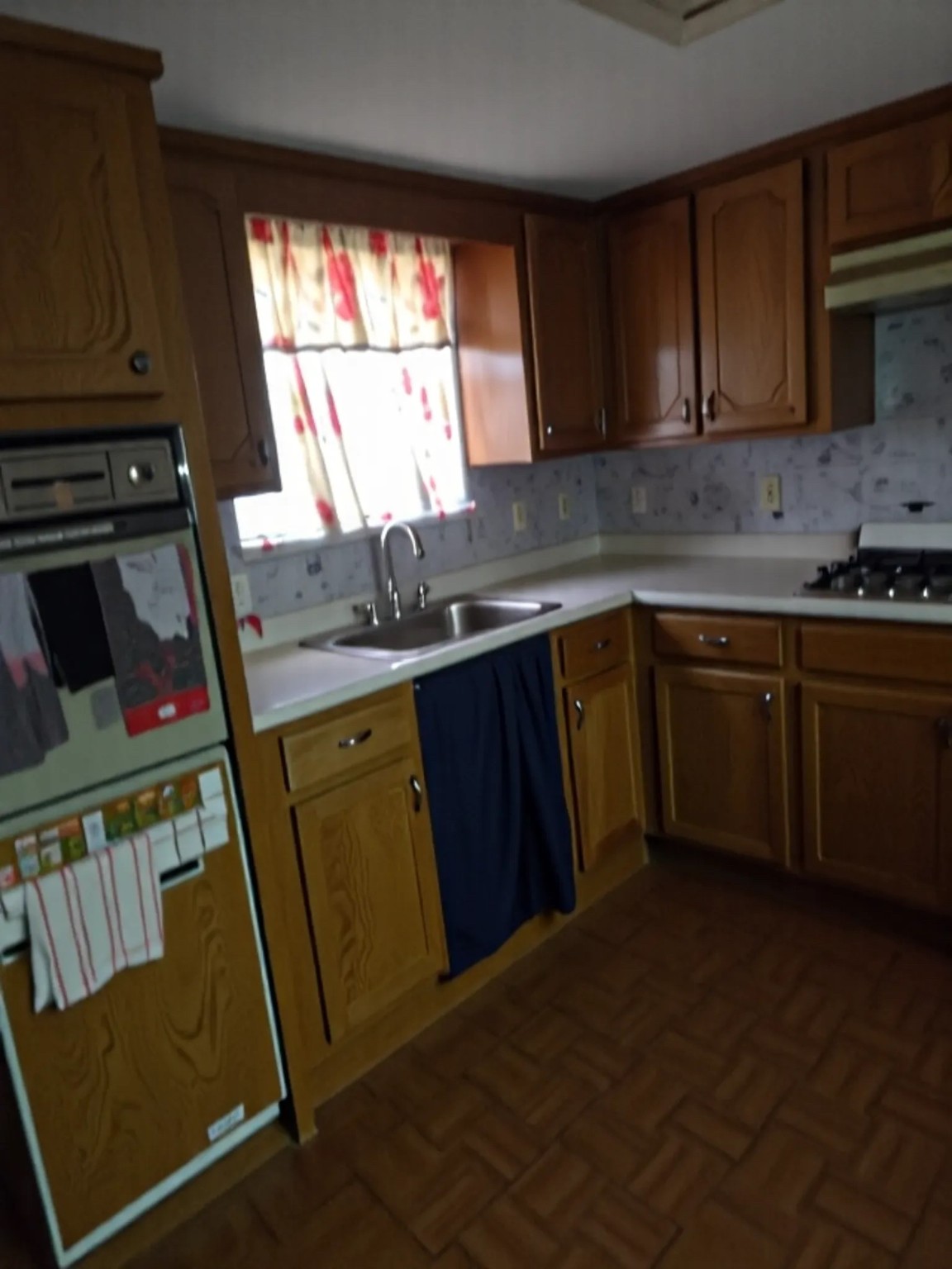 1305 2nd Street Hempstead, TX 77445 - Photo 5 of 24 a kitchen with a sink a stove a microwave and cabinets