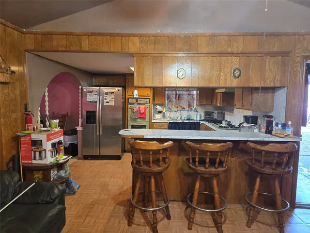 a kitchen with stainless steel appliances a sink and a refrigerator