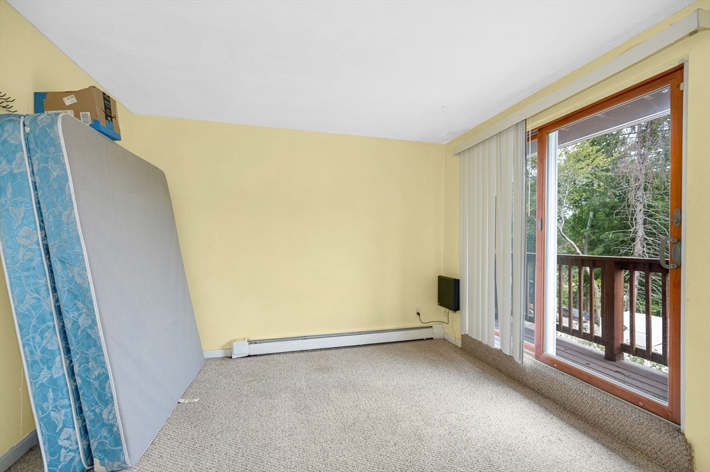 110 Boston Post Road East, Unit 104 Marlborough, MA 01752 - Photo 15 of 25 a view of an empty room with wooden floor and a window