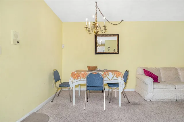 a view of a dining room with furniture and chandelier