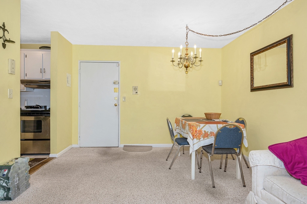 110 Boston Post Road East, Unit 104 Marlborough, MA 01752 - Photo 5 of 25 a view of a dining room with furniture and a chandelier