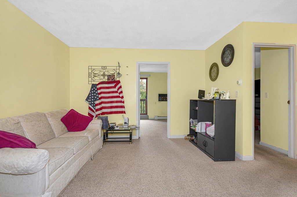 110 Boston Post Road East, Unit 104 Marlborough, MA 01752 - Photo 6 of 25 a living room with furniture and a flat screen tv