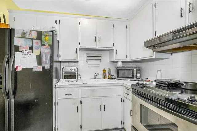 a kitchen with stainless steel appliances a sink stove and refrigerator
