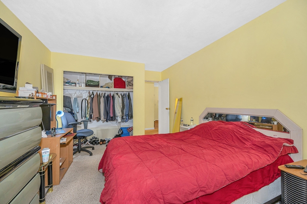 110 Boston Post Road East, Unit 104 Marlborough, MA 01752 - Photo 10 of 25 a bed room with a bed and a television