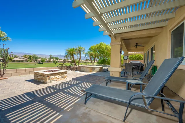 a view of a patio with swimming pool table and chairs