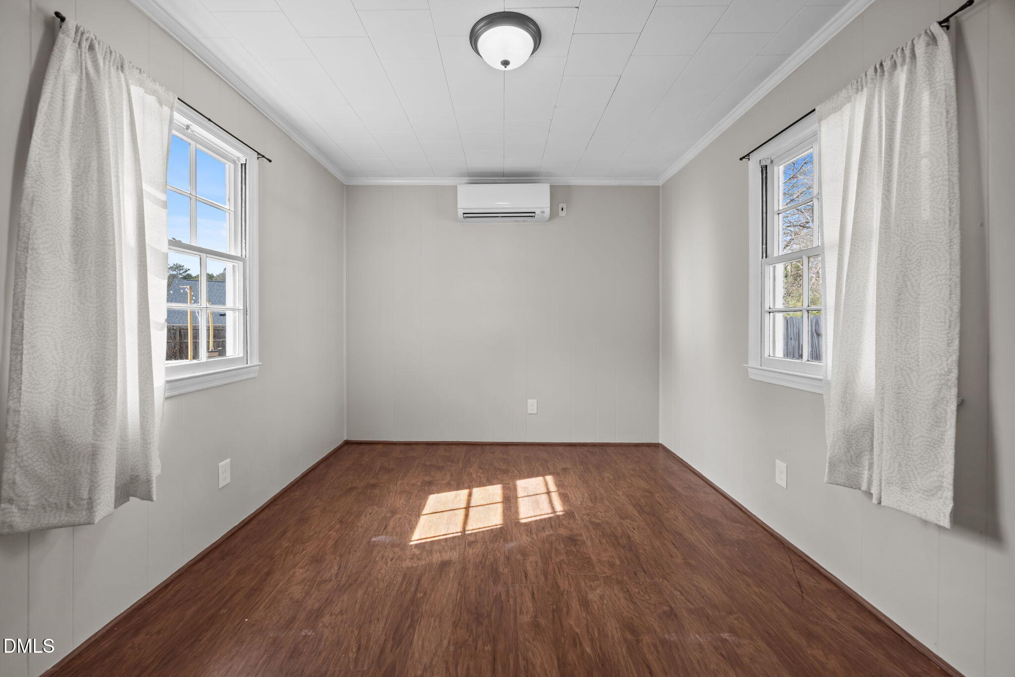 209 Weston Road Garner, NC 27529 - Photo 18 of 37 an empty room with wooden floor and windows