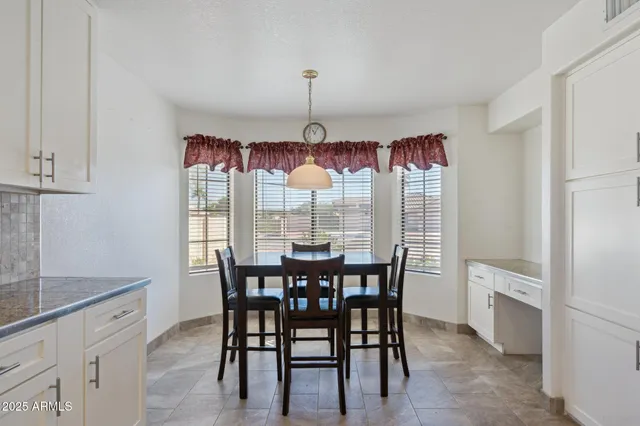 a living room with furniture chandelier and a table