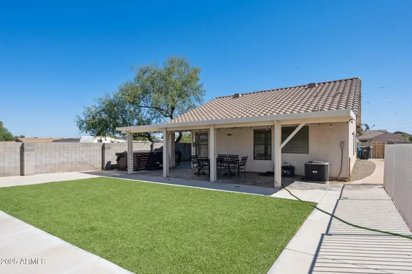 a view of a backyard with swimming pool
