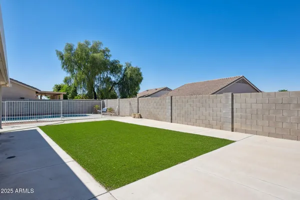 a front view of a house with patio and a garden