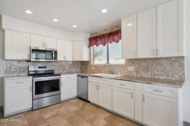 a living room with furniture a couch and a chandelier