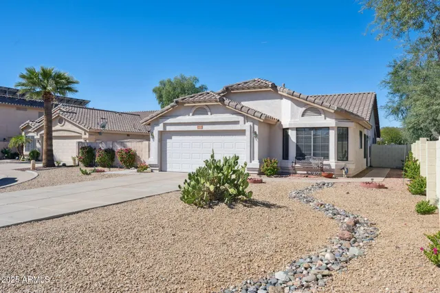 a kitchen with granite countertop white cabinets stainless steel appliances and a window