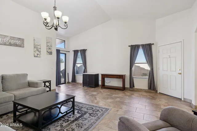 a view of a house with pool and chairs