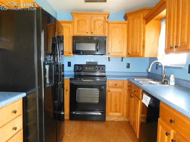 a kitchen with stainless steel appliances a stove sink and microwave
