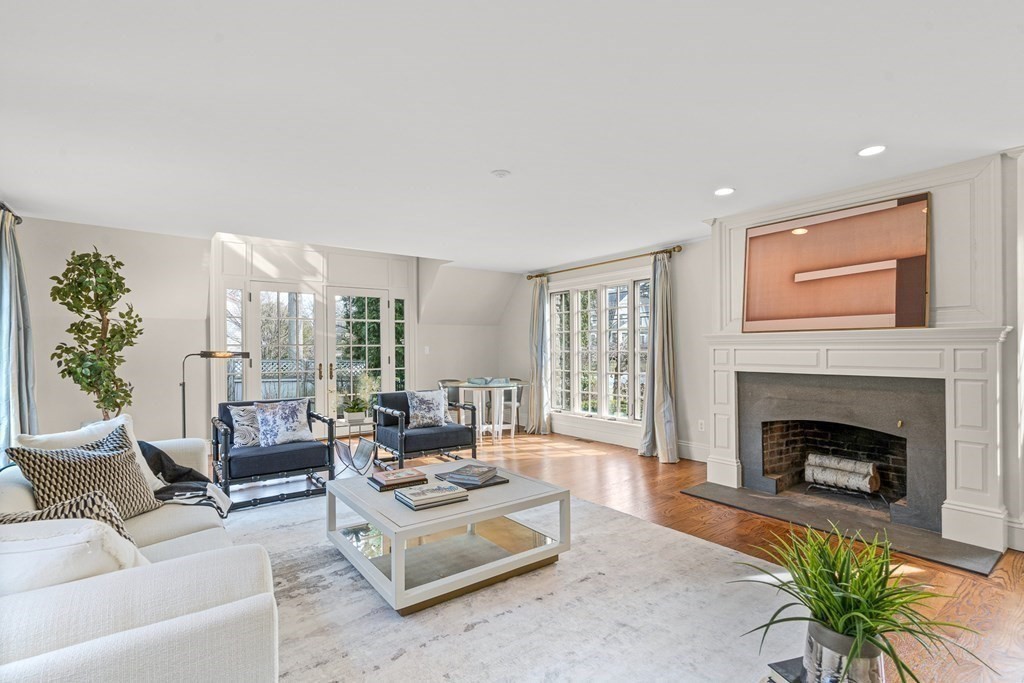 77 Cliff Road Wellesley, MA 02481 - Photo 17 of 33 a living room with furniture a fireplace and a floor to ceiling window