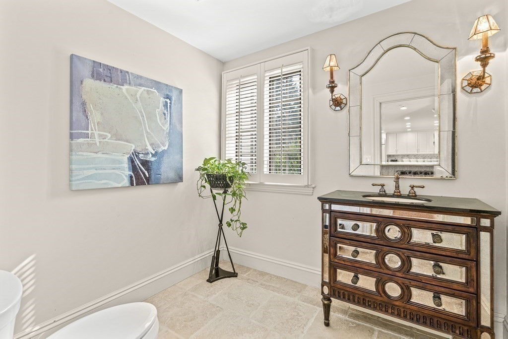 77 Cliff Road Wellesley, MA 02481 - Photo 18 of 33 a bathroom with a granite countertop sink a toilet and a mirror