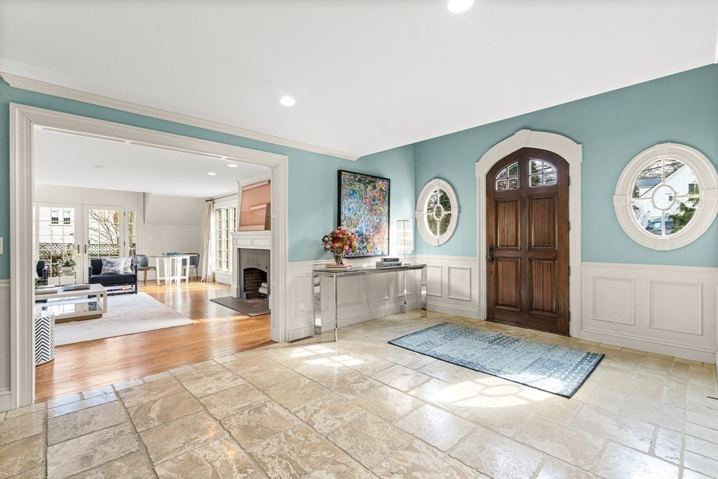 77 Cliff Road Wellesley, MA 02481 - Photo 19 of 33 a view of a hallway to a livingroom with furniture cabinet and a kitchen view