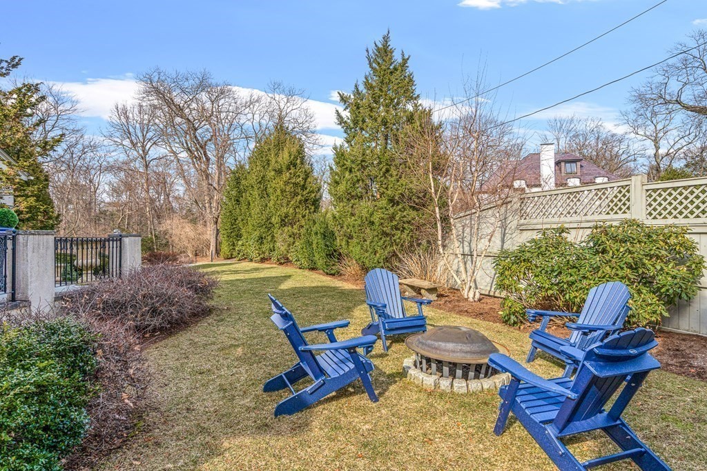 77 Cliff Road Wellesley, MA 02481 - Photo 32 of 33 a backyard of a house with outdoor seating
