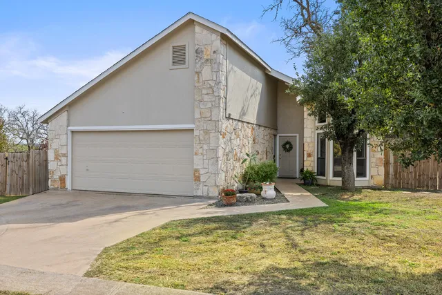a view of a white house with a large pool of the house