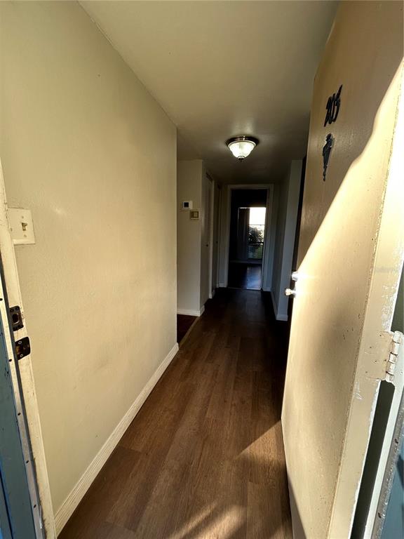 2811 Southwest Archer Road, Unit X203 Gainesville, FL 32608 - Photo 1 of 1 a view of a hallway with wooden floor and staircase