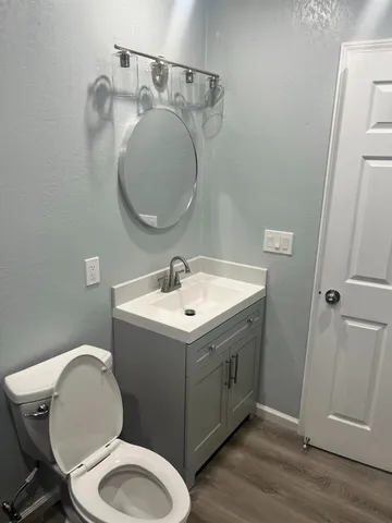 a bathroom with a toilet sink and mirror