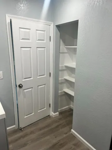 an empty room with wooden floor