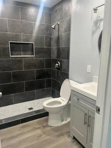 a bathroom with a toilet and a shower