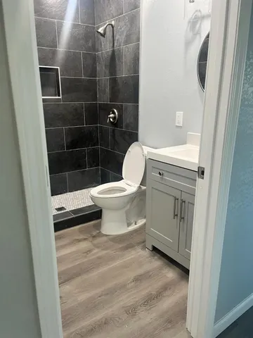 a bathroom with a toilet and a shower